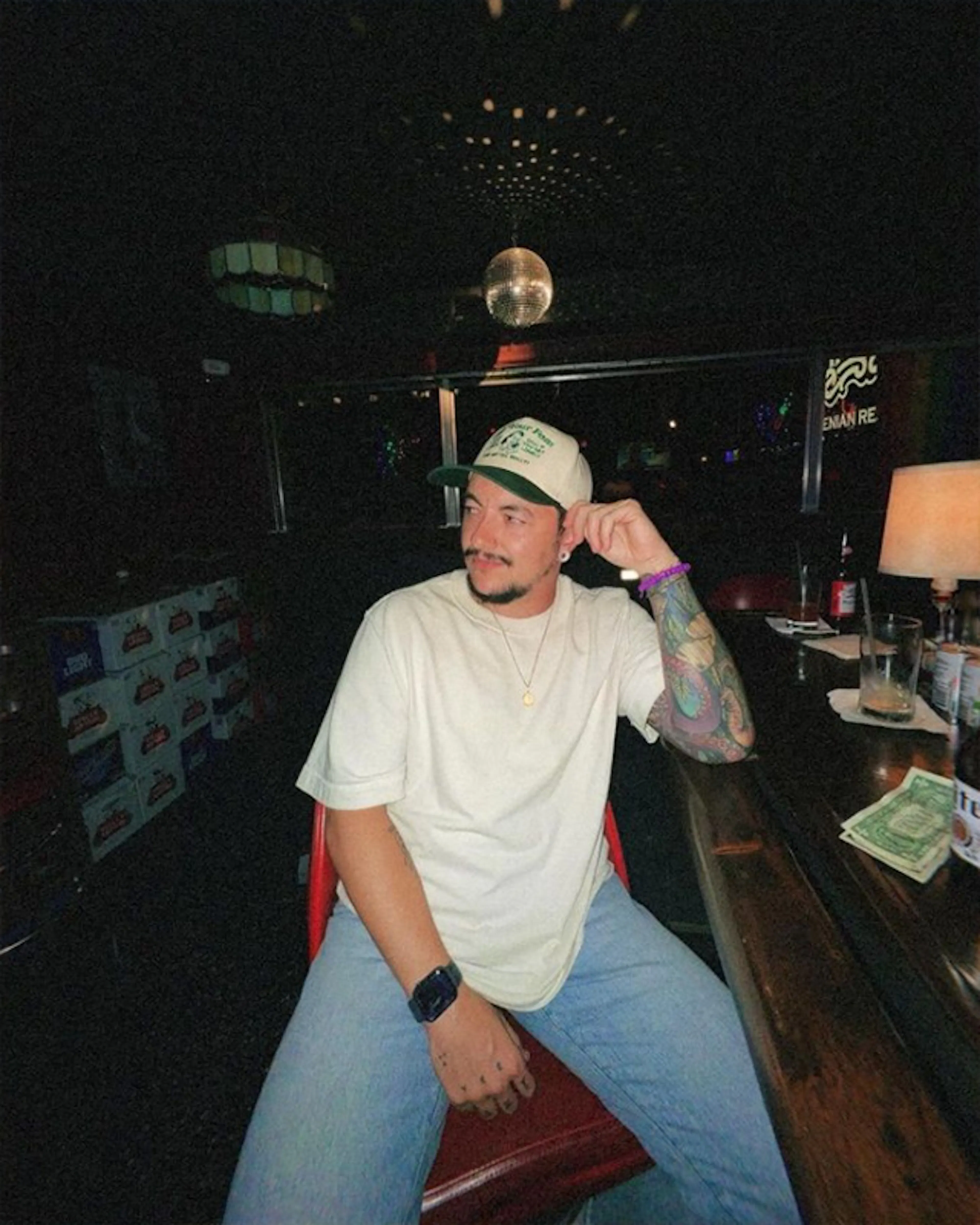 Chris Rhodes sitting at a dimly lit bar