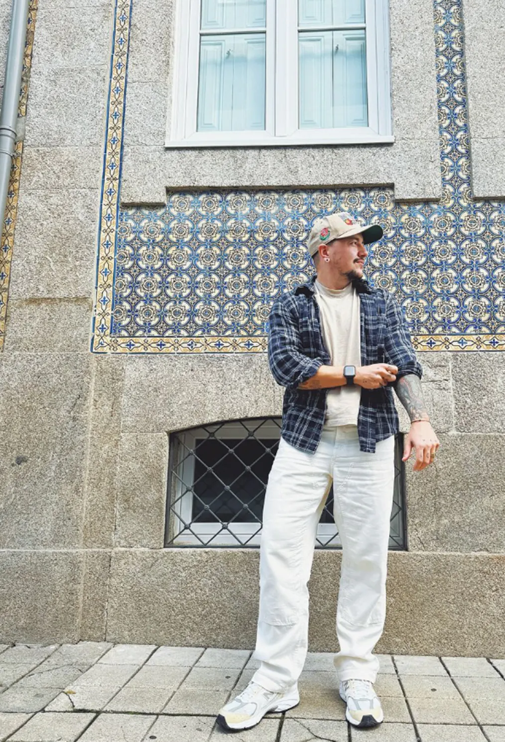 Chris Rhodes standing in front of a tiled building facade