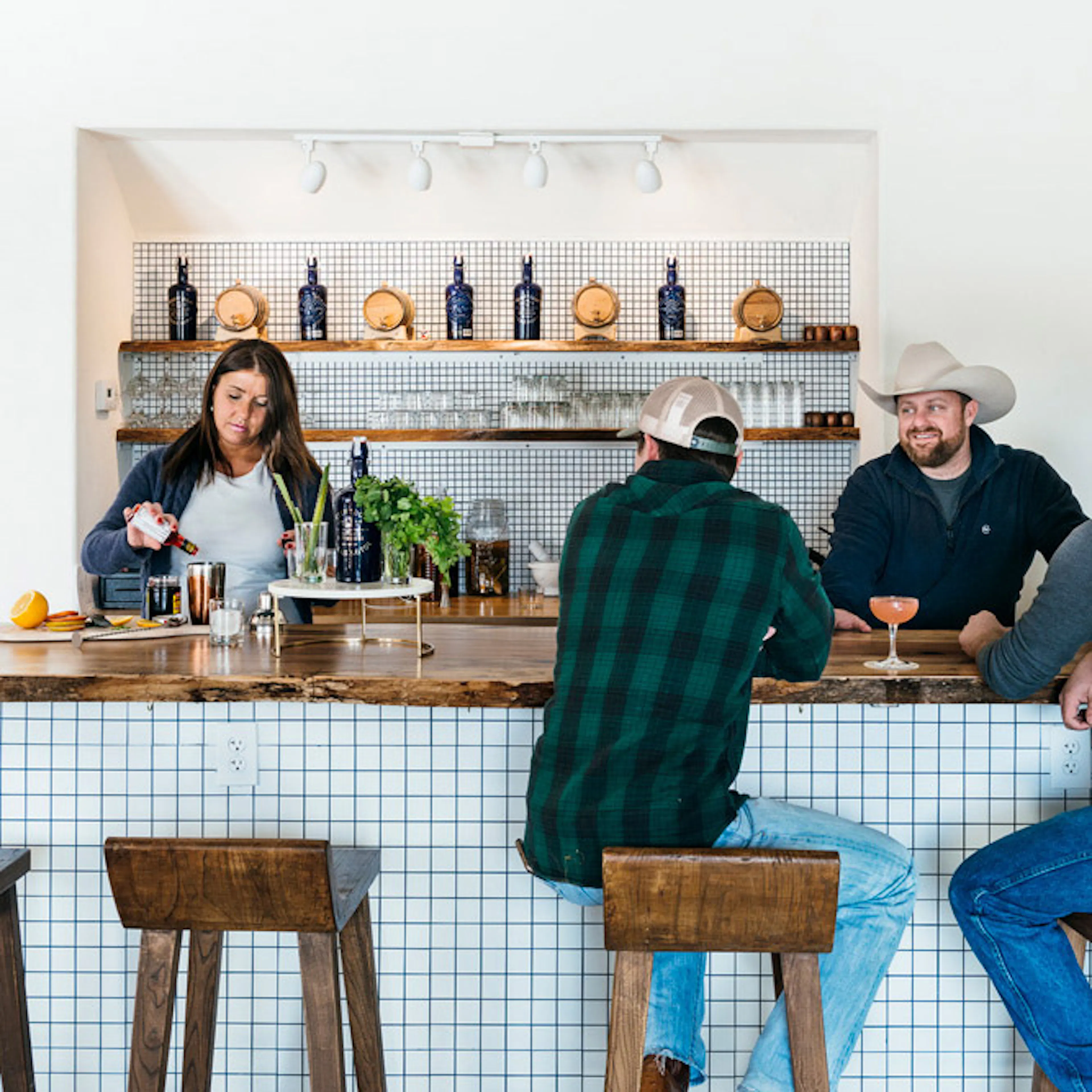 Guests at the Desert Door tasting room bar while a bartender mixes drinks