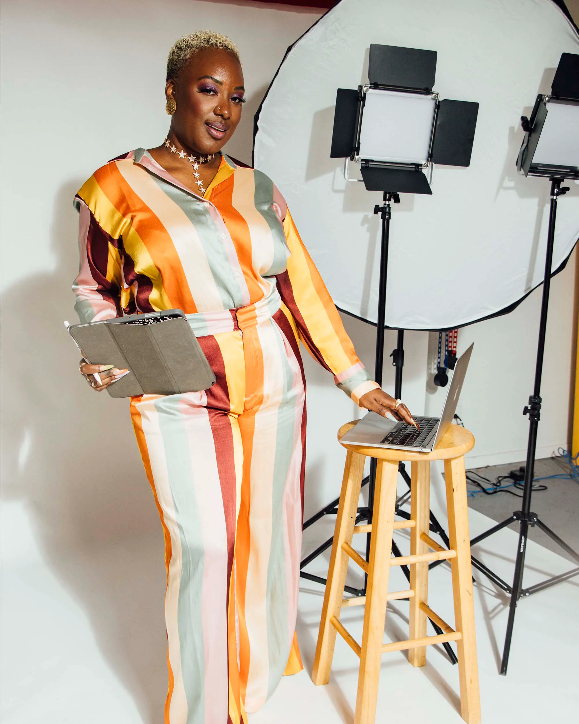 Gabriella Layne-Avery with a clipboard and laptop in a photo studio
