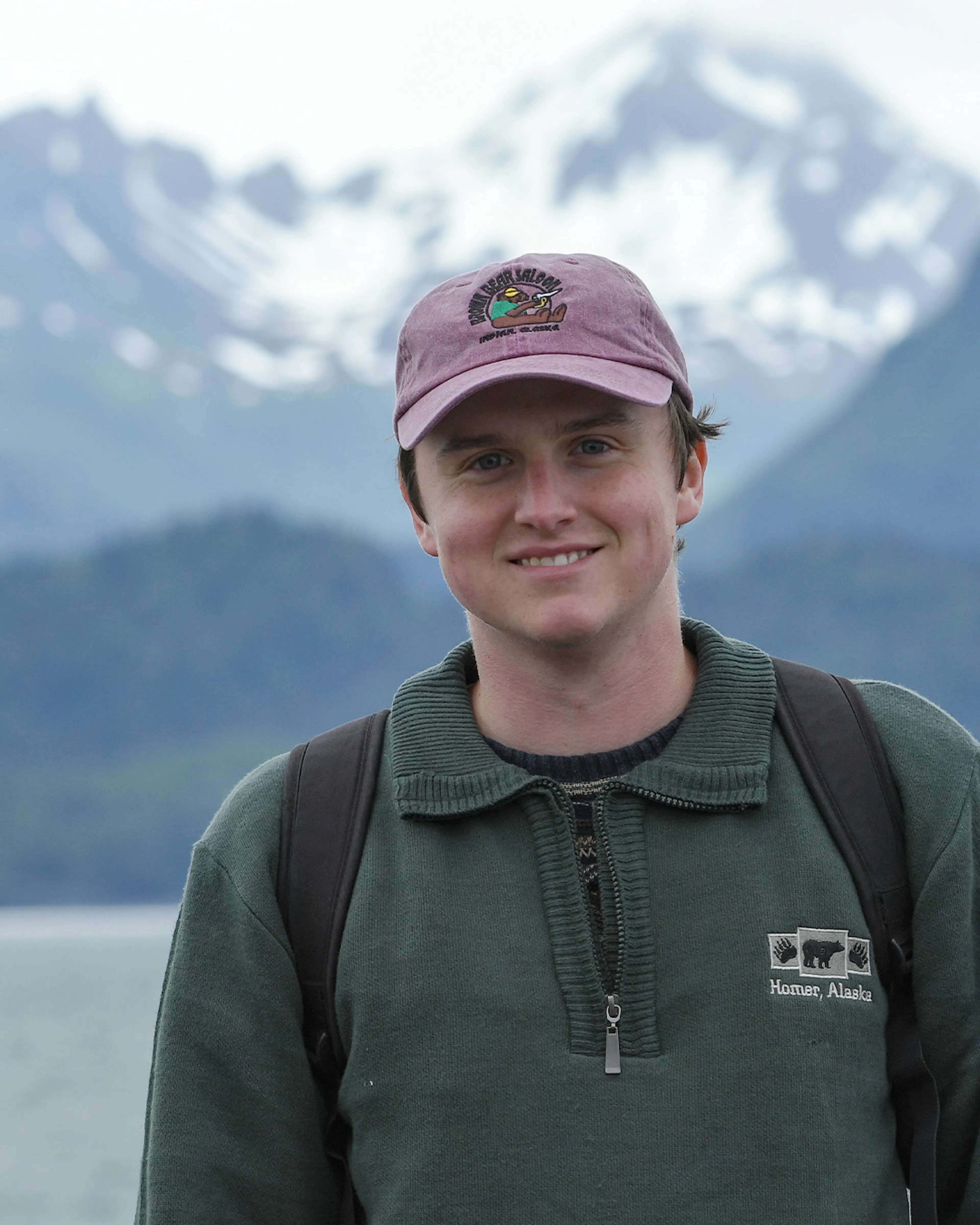 Jack Nailor smiling in front of snowy mountains