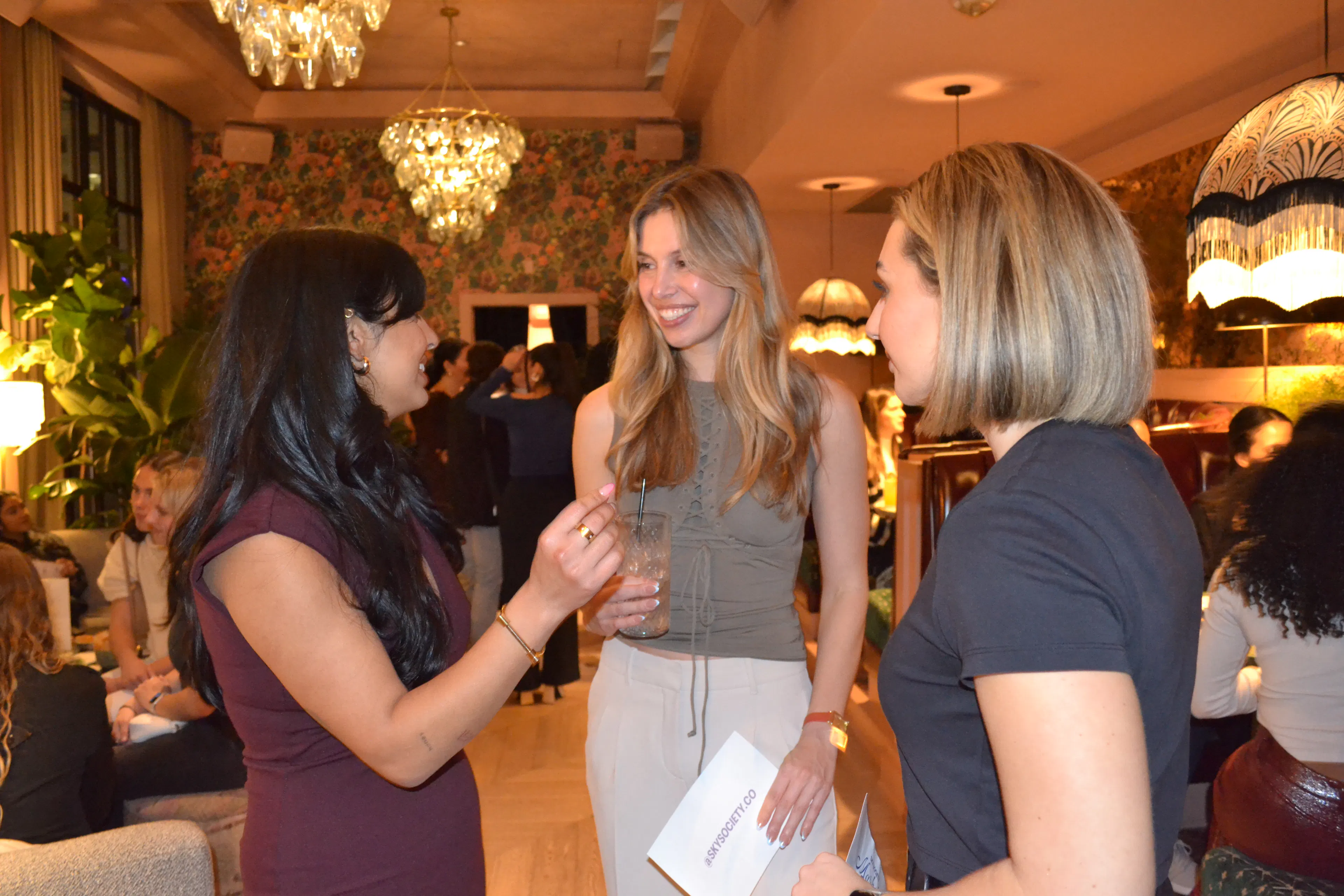 Natalie Peters talking with two guests at an event