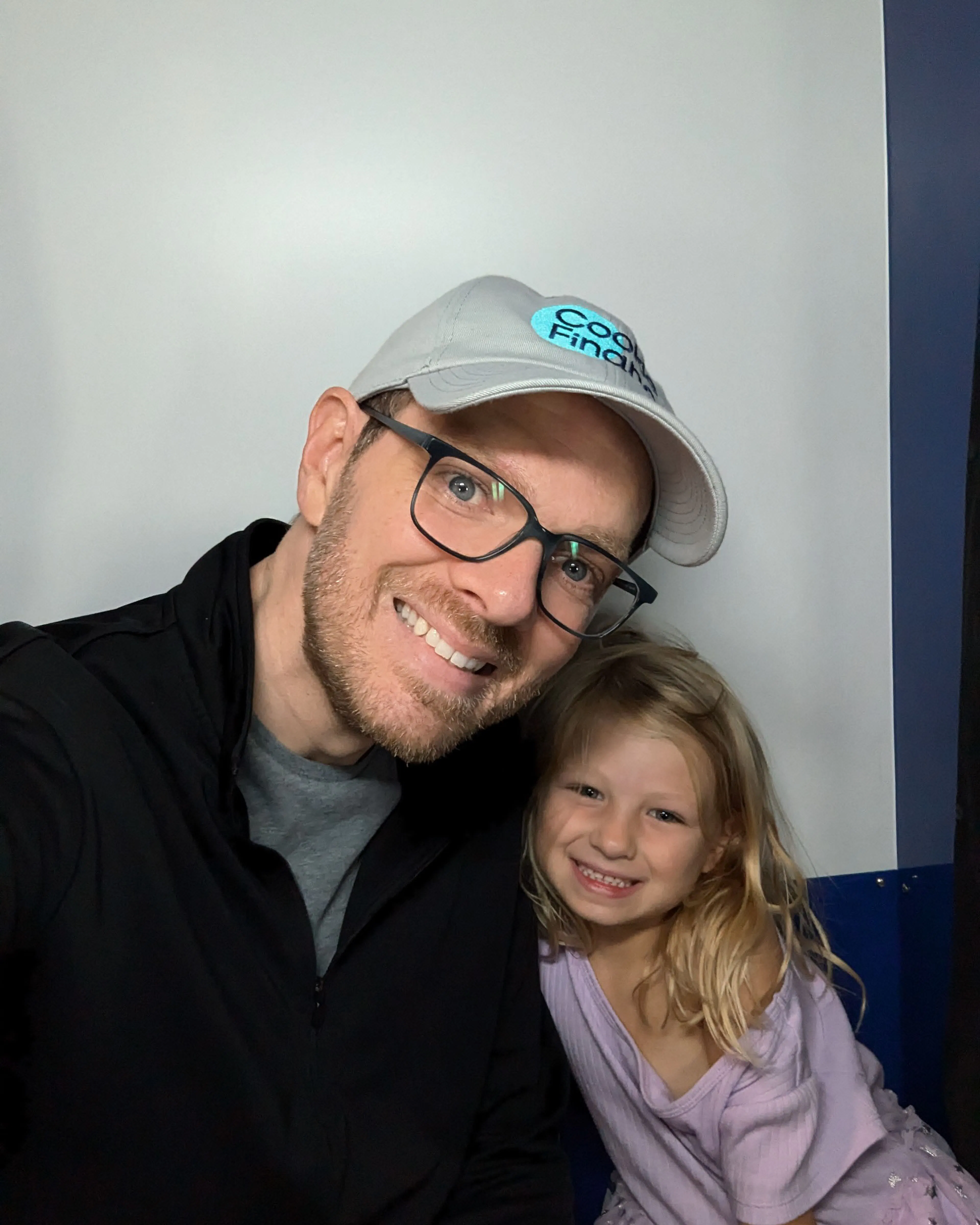 Nate Coughran in a Cookie Finance cap taking a selfie with a young girl