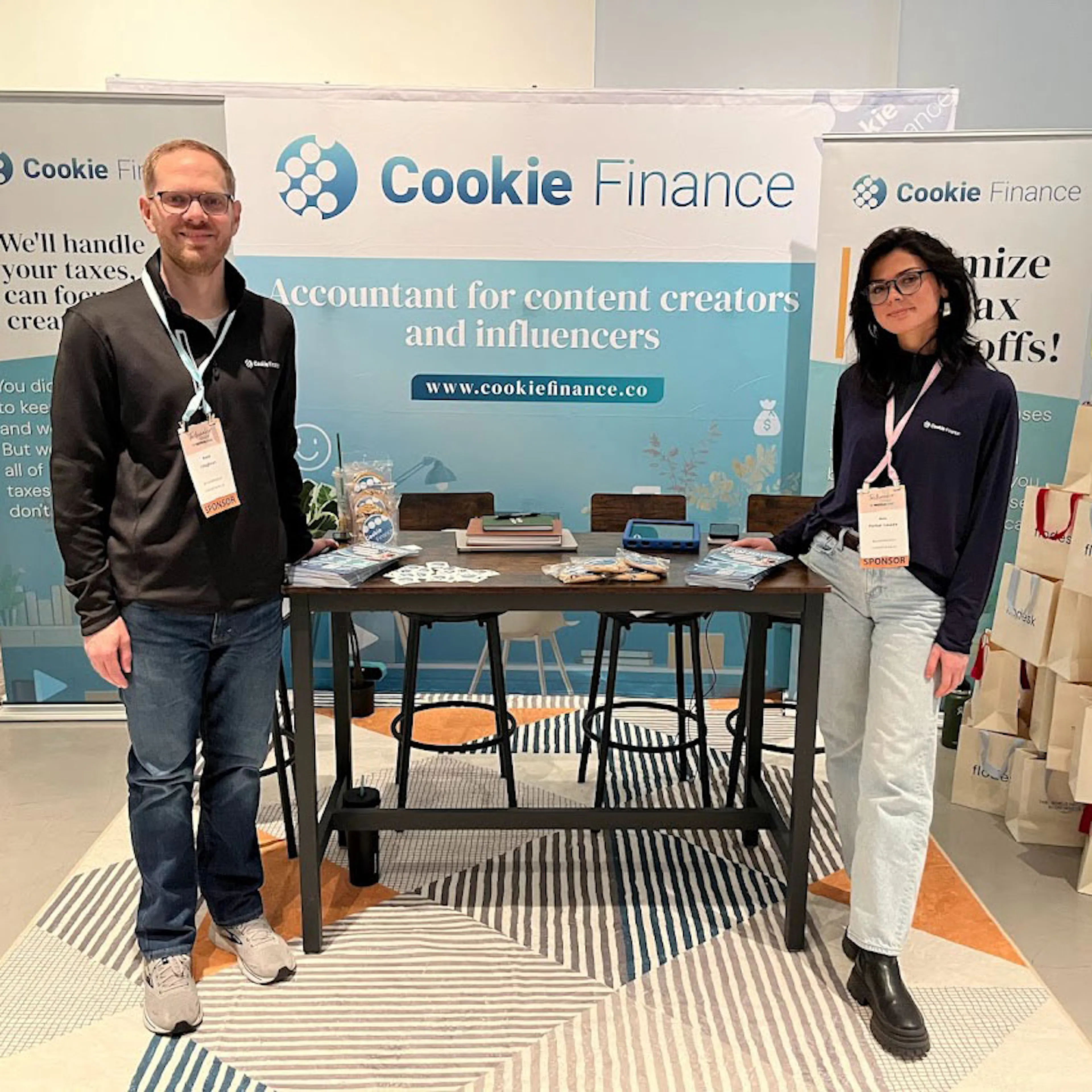 Nate Coughran and a colleague standing at the Cookie Finance booth