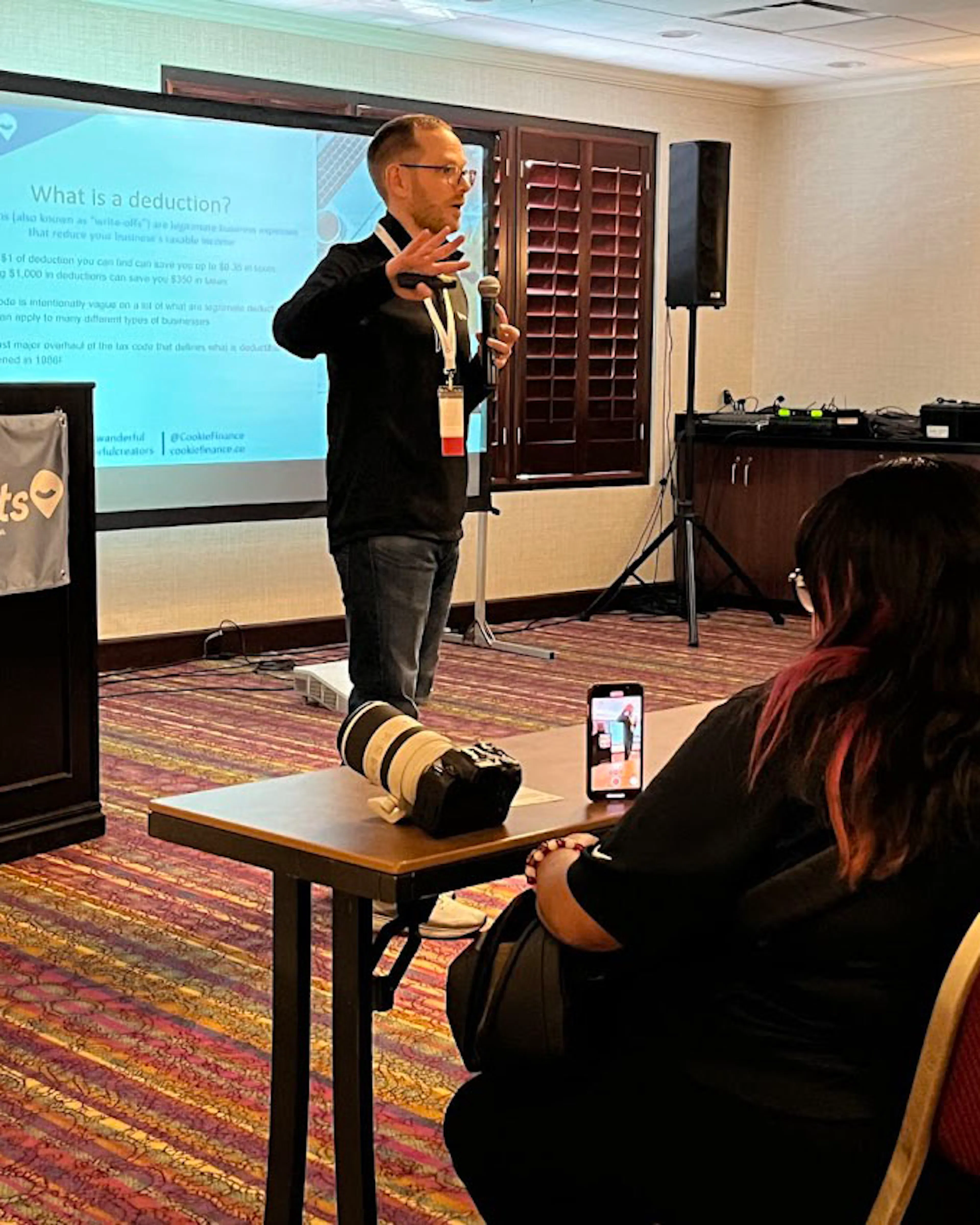 Nate Coughran presenting to an audience in a conference room