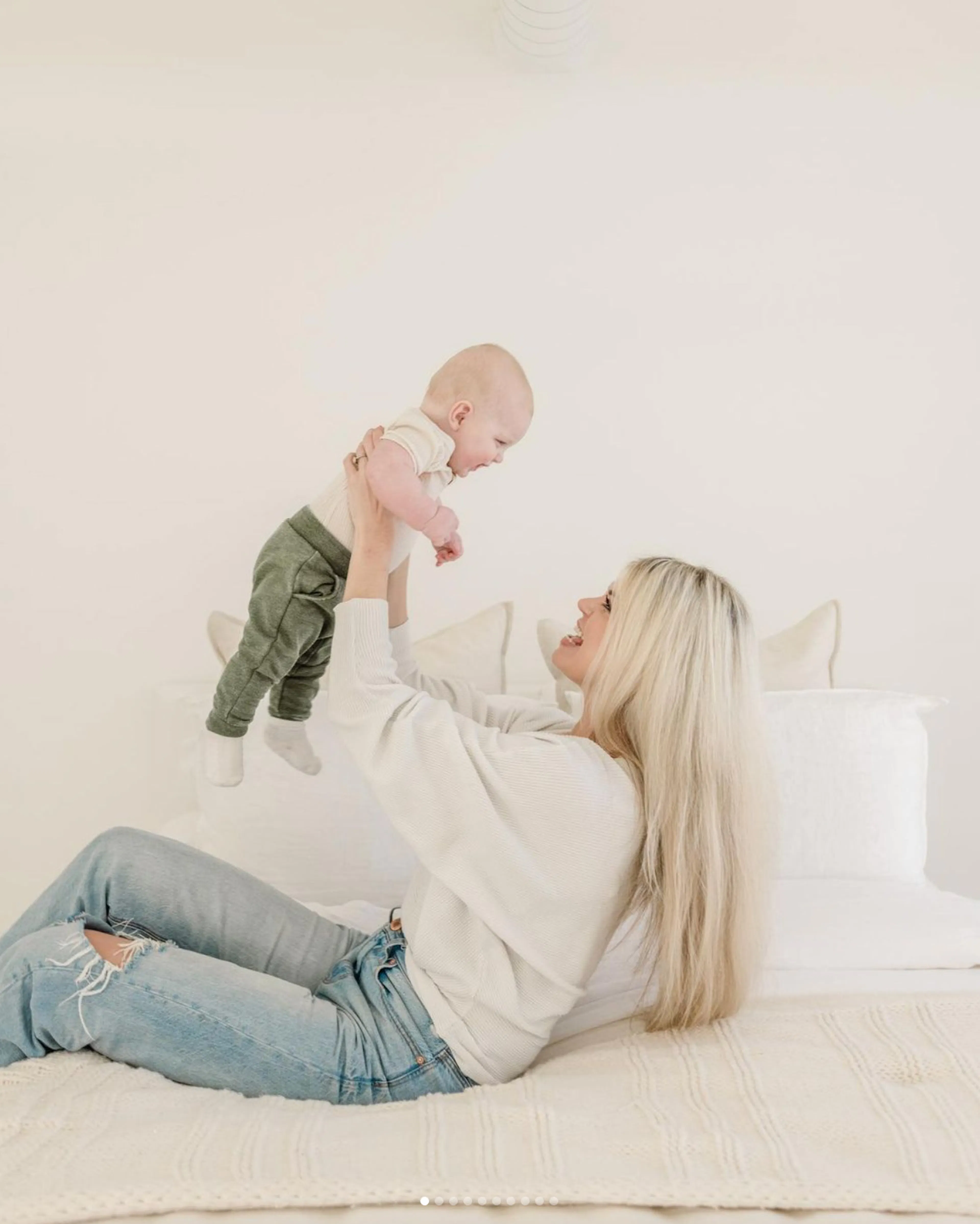 Sydney Dozier holding a baby up in the air